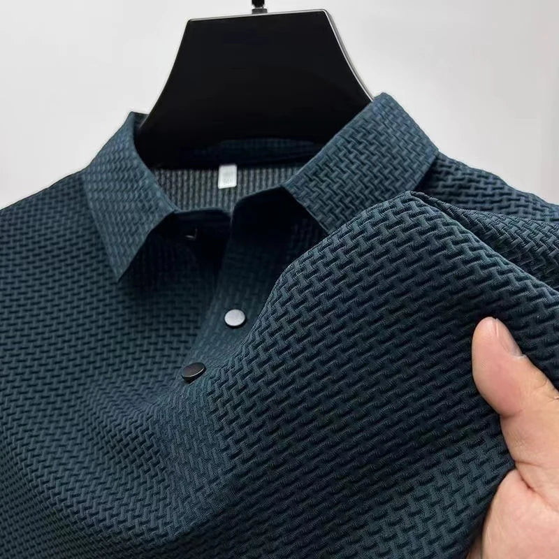 Green textured polo shirt on a hanger with a hand holding it