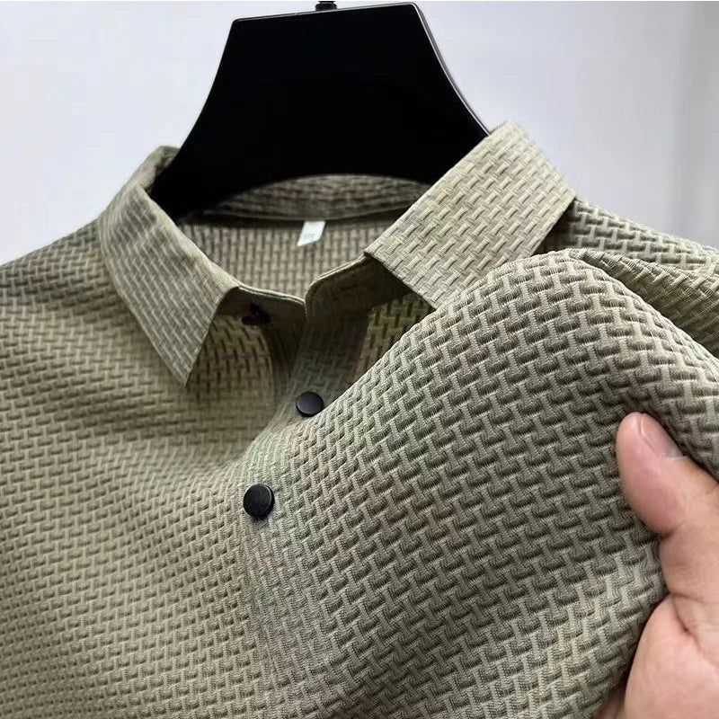 Beige textured polo shirt on a hanger with a hand holding it